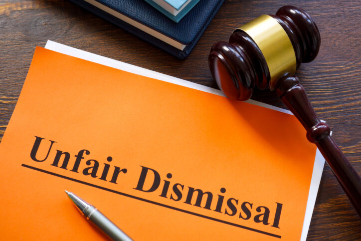 A Report about unfair dismissal with book on the table.