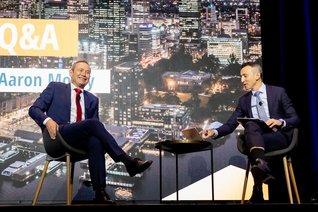 WA Premier Roger Cook and CCIWA chief Economist Aaron Morey sitting in chairs talking to each other.