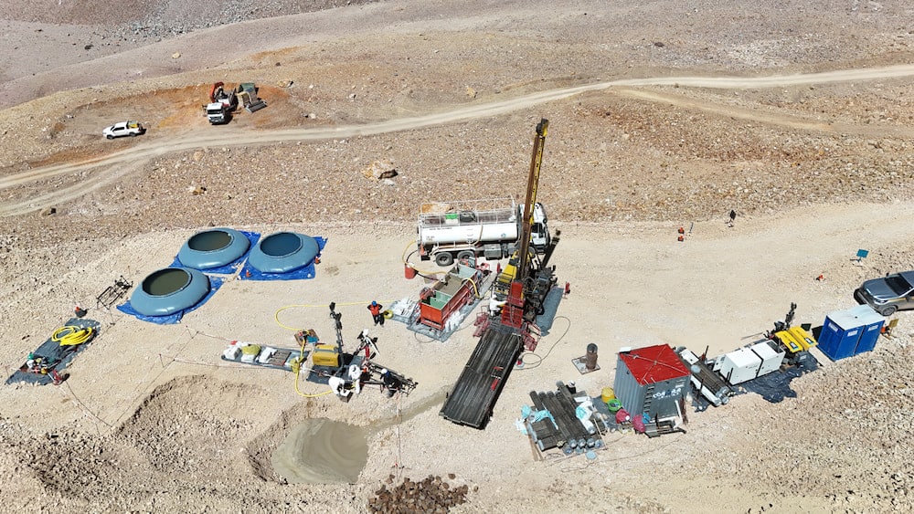 A group of people gathered around a truck at a mine site.