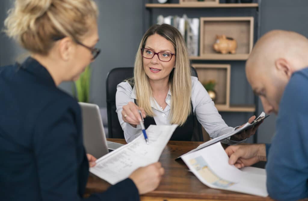 Commercial lawyer and clients discuss intellectual property for their business.