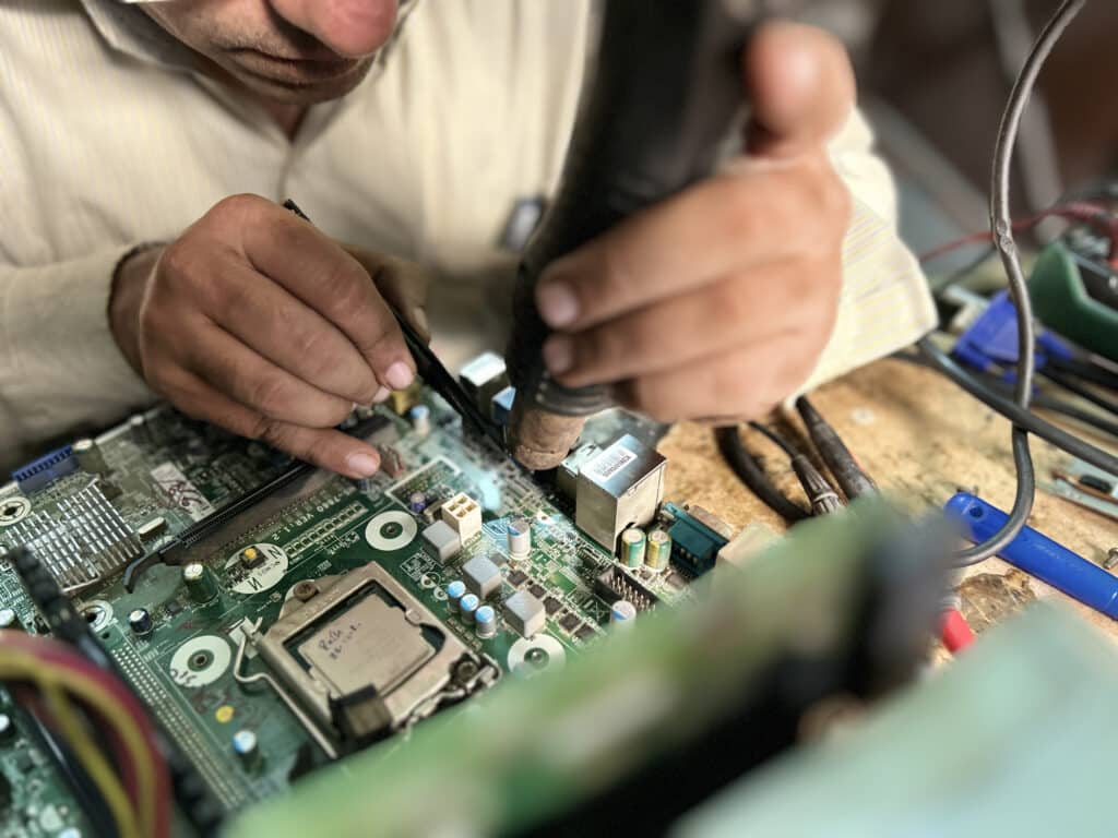 Close up of Man repairing Computer Motherboard. Electronic engineer repairs circuit board. Close up of Man repairing Computer Motherboard. Electronic engineer repairs circuit board.