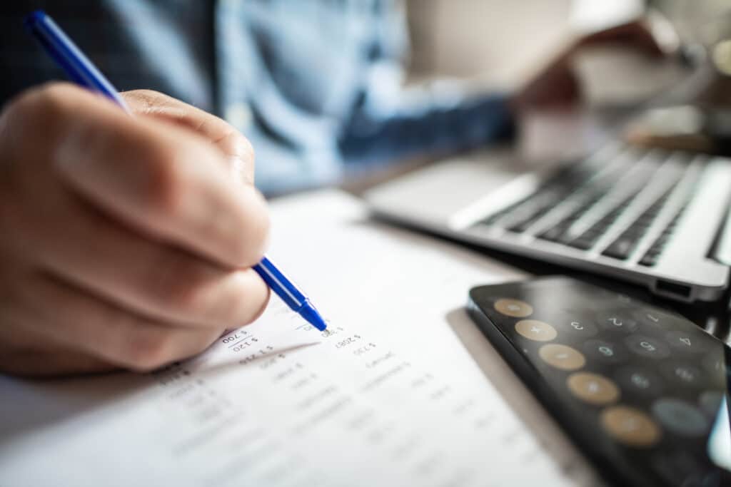 Man with financial documents working on business accounts and superannuation.
