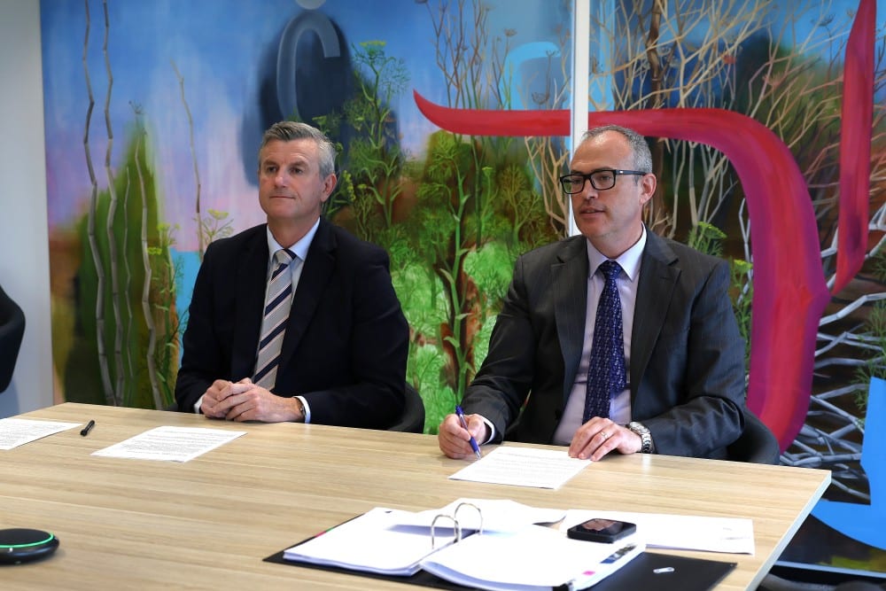CCIWA CEO Will Golsby and Chief Economist Dr Daniel Kiely seated at a table with documents during a Productivity Commission hearing on WA’s GST deal.